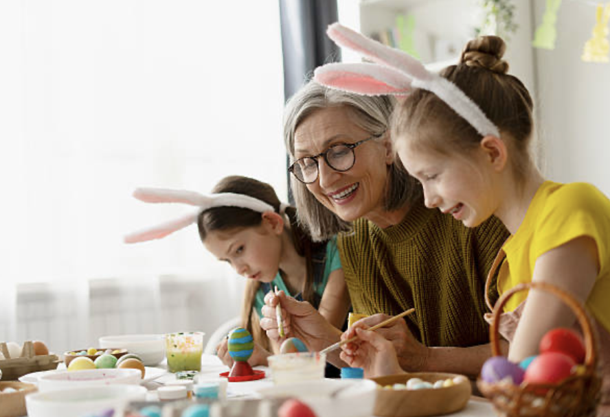 Children with bunny rabbit ears playing with a grandmother at Easter